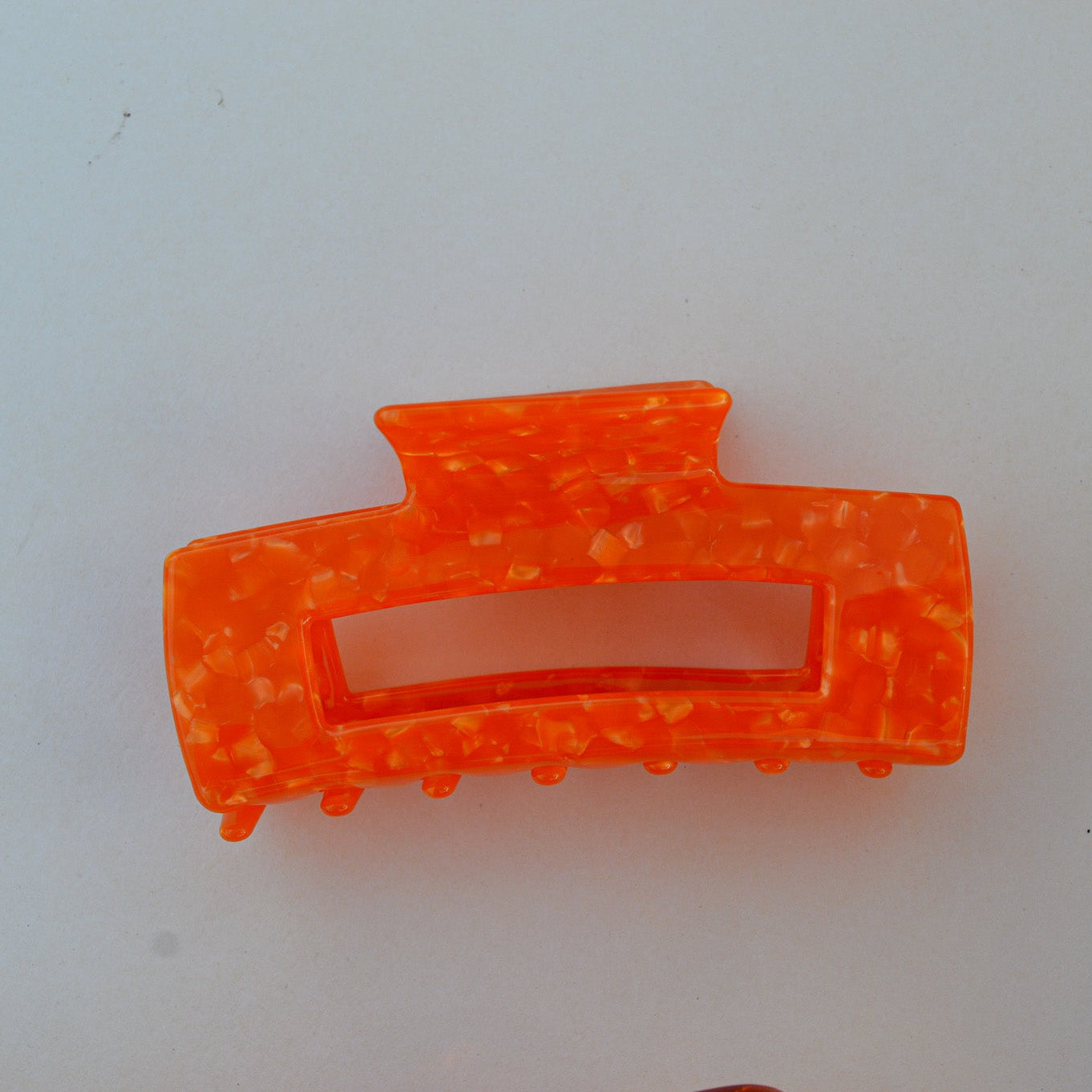 Orange hair clip on a white background