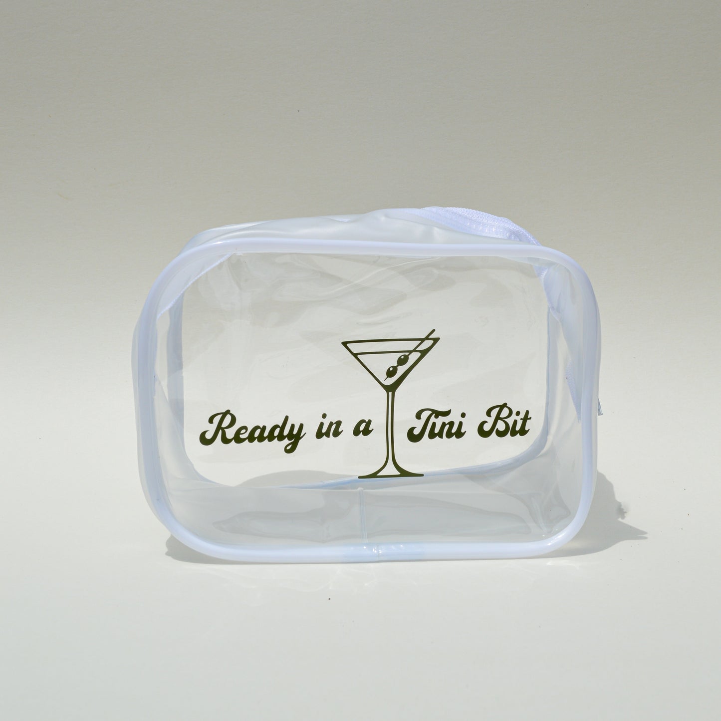Clear pouch with text and a martini glass design on a light gray background