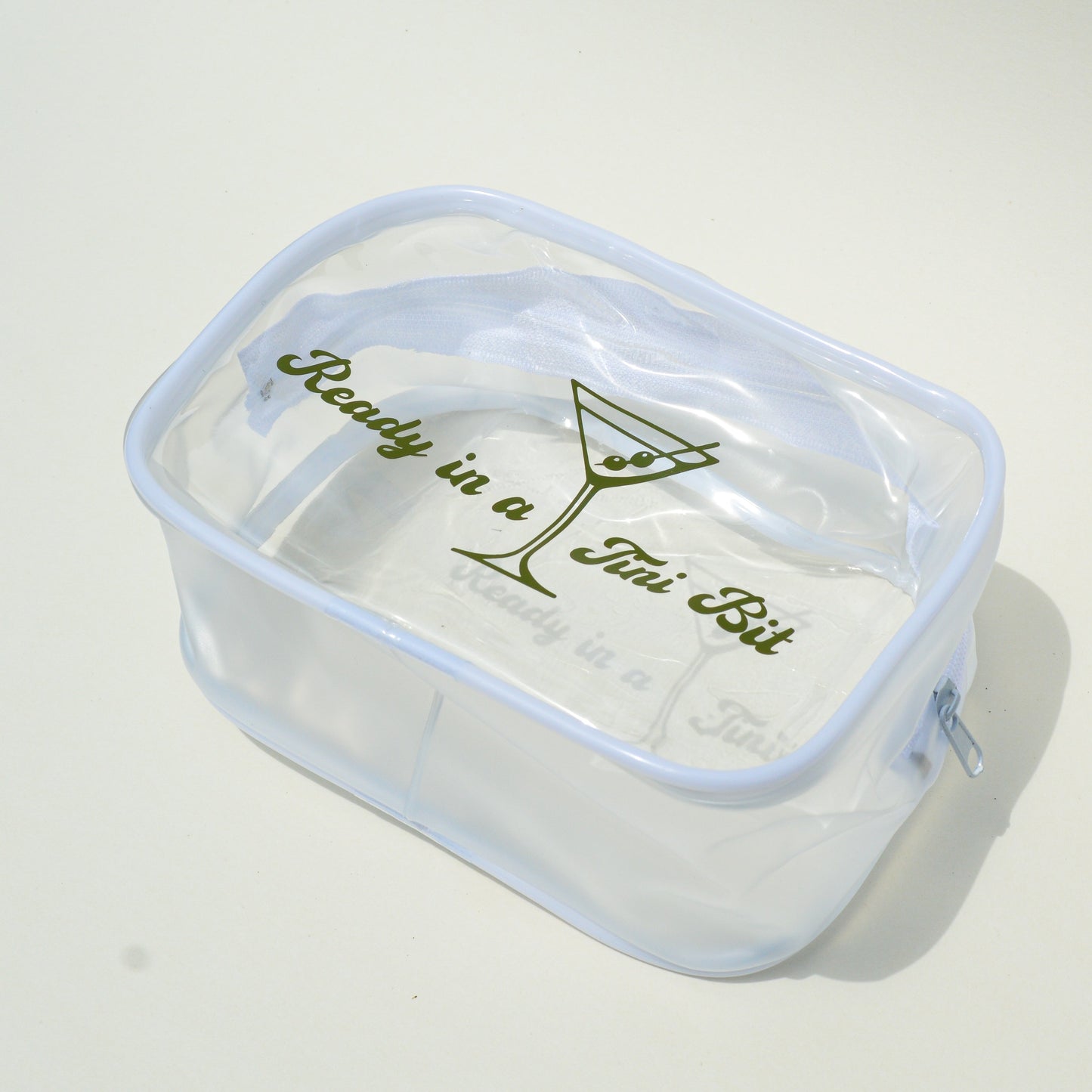 Clear plastic container with text and a martini glass graphic on a white background