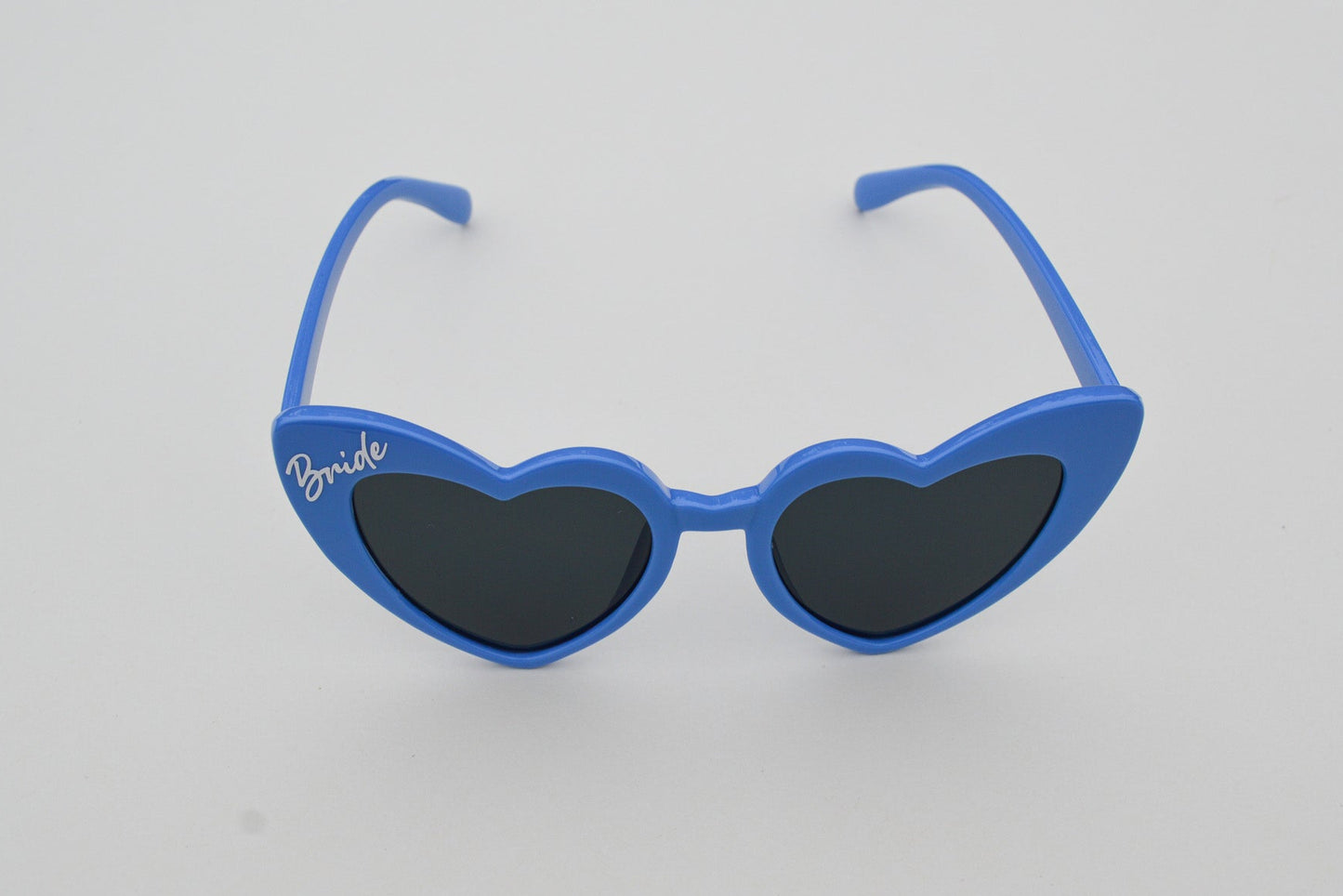Blue sunglasses with heart-shaped lenses on a white background