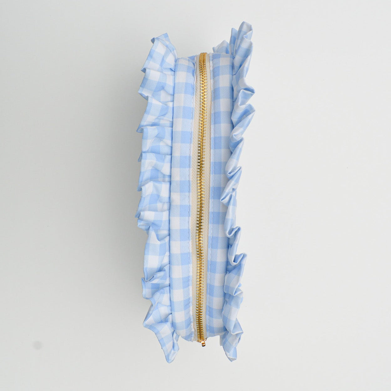Blue checkered pouch with a gold zipper on a white background