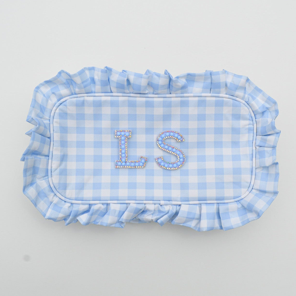 Blue checkered fabric pouch with 'LS' pearl letters on a white background