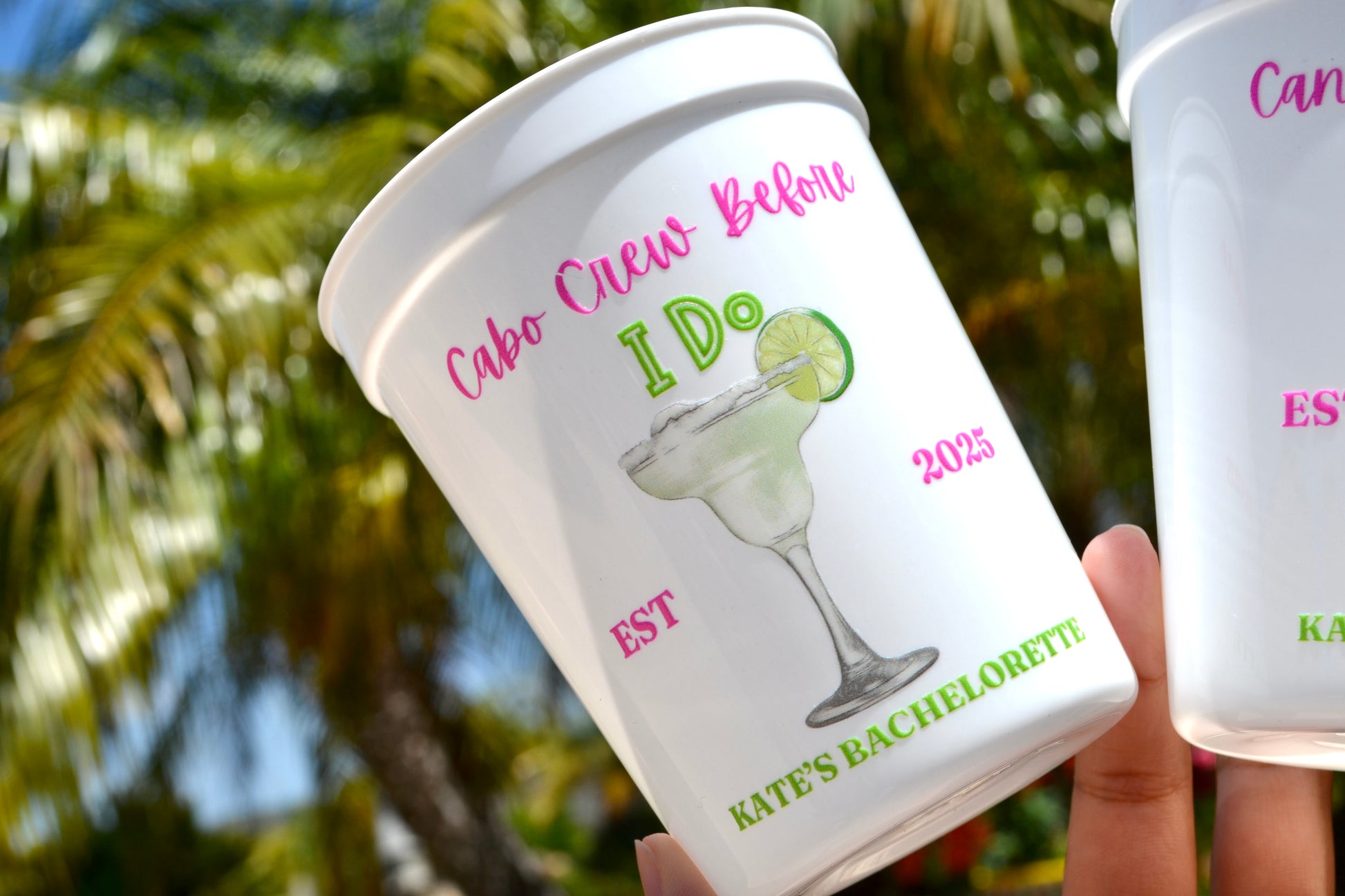 Personalized cup with 'Cabo Crew Before I Do' text and a margarita graphic, held outdoors.