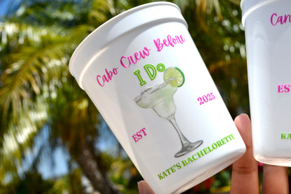 Personalized cup with 'Cabo Crew Before I Do' text and a margarita graphic, held outdoors.