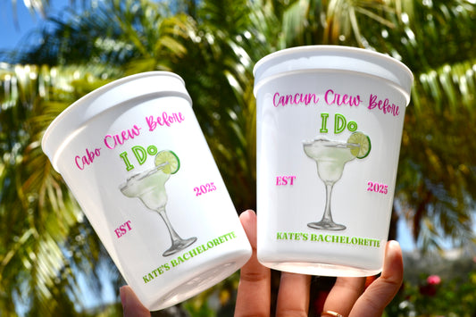 Two cups with personalized designs and text against a blurred natural background