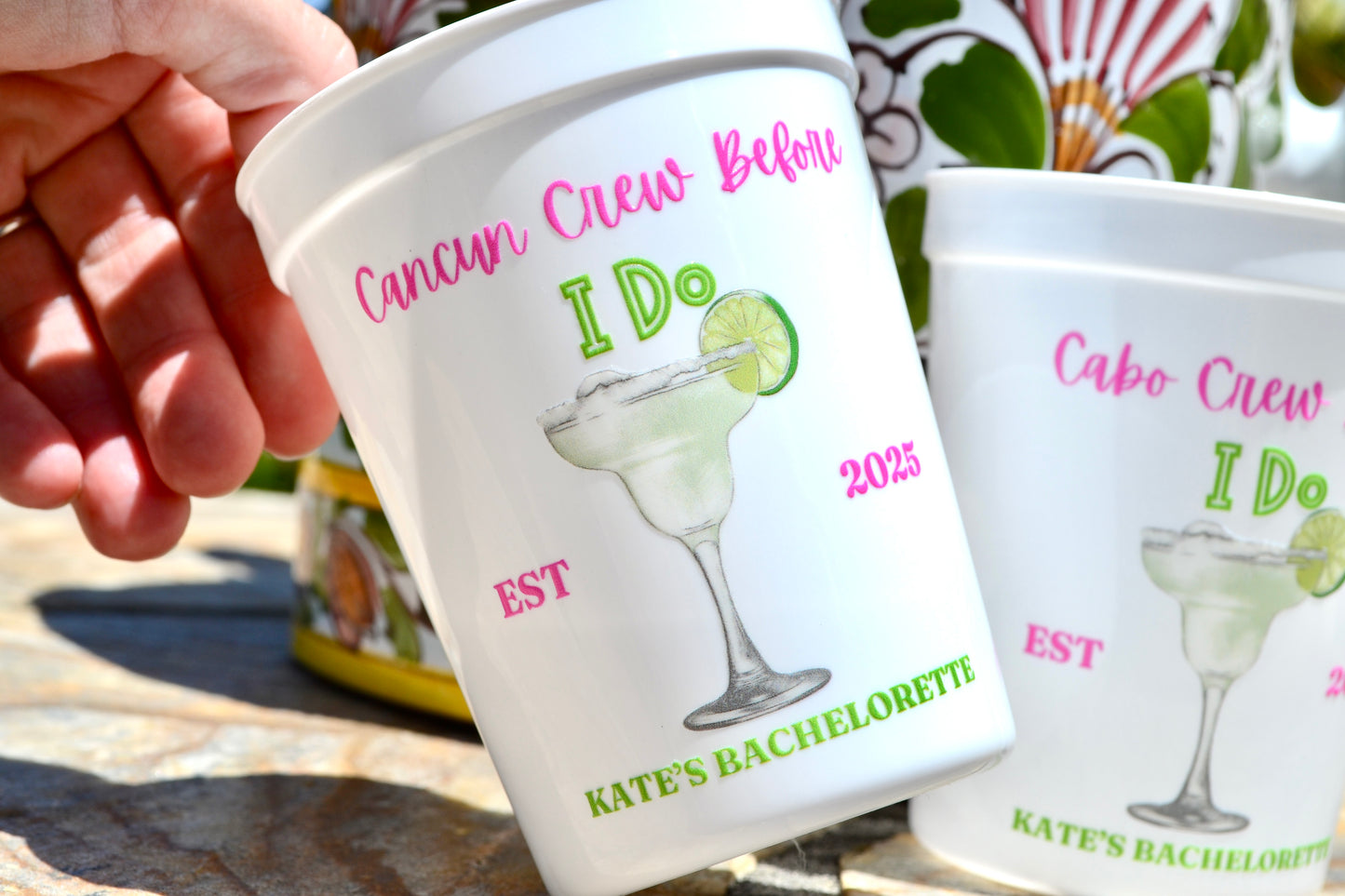 Personalized cups with bachelorette party designs and text.