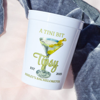 Personalized cup with cocktail illustration and text on a soft fabric background