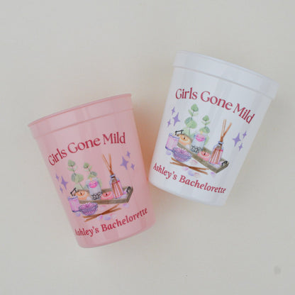 Two pink and white cups with 'Girls Gone Mild' text on a light gray background