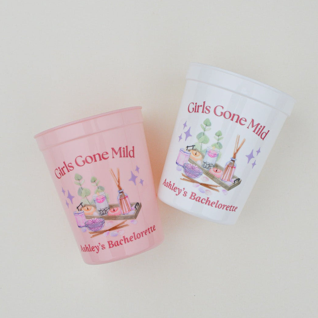 Two cups with 'Girls Gone Mild' text and floral designs on a light background