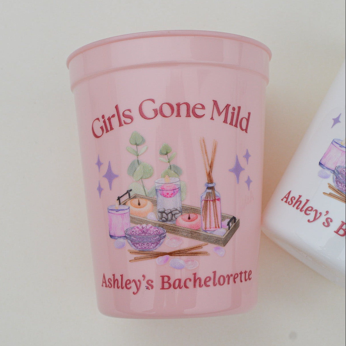 Pink 'Girls Gone Mild' bachelorette cup with decorative elements on a white background