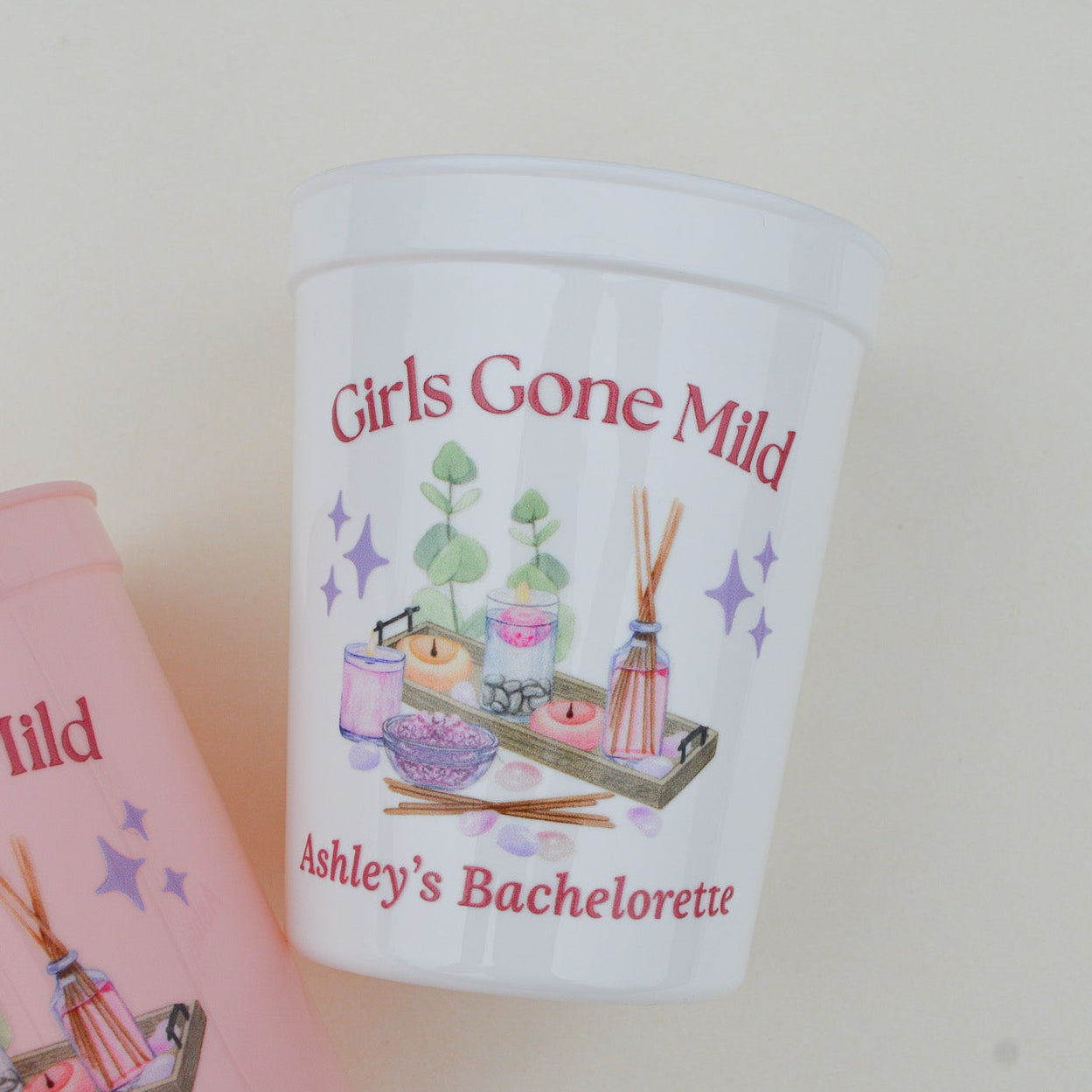 Personalized 'Girls Gone Mild' bachelorette party cup with pink card in the background.