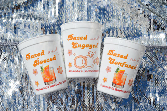 Three personalized party cups with text and graphics on a textured background