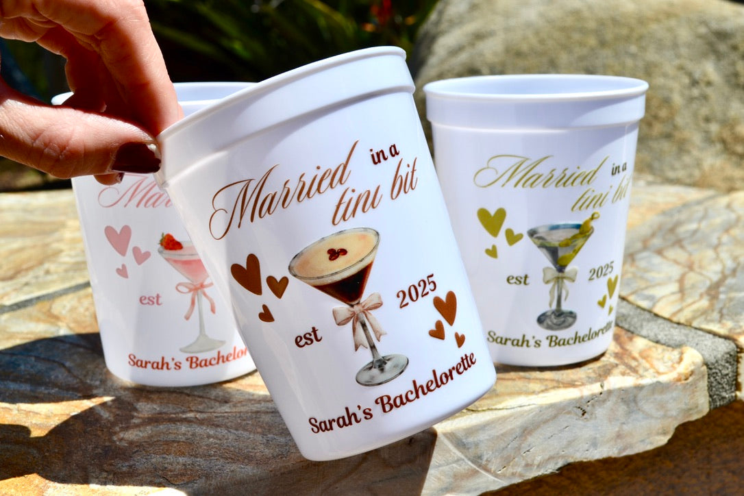 Personalized cups with text and graphics on a stone surface