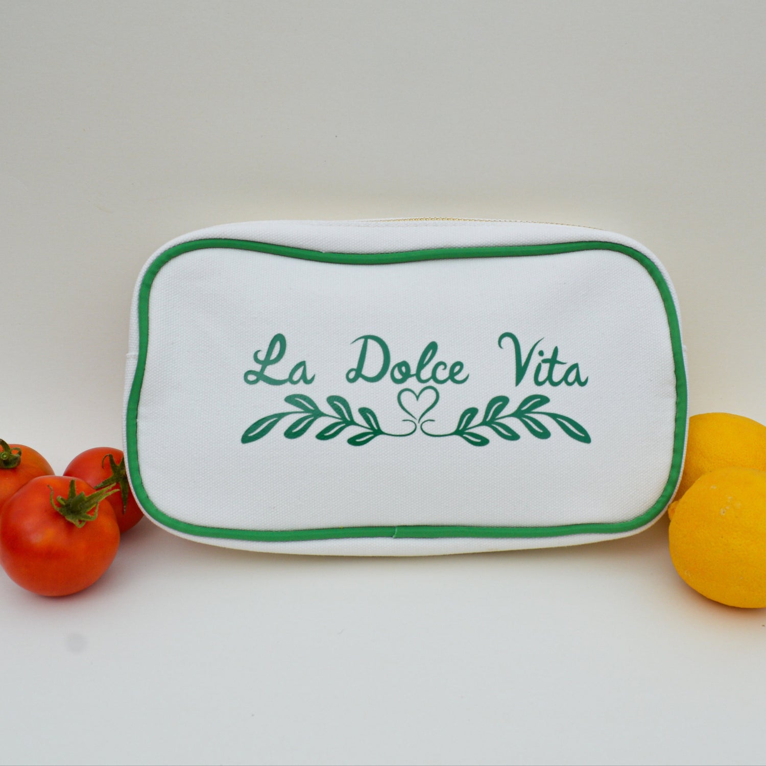 White bag with green trim and green lettering that says 'La Dolce Vita' on a white background