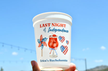 Cup with 'Last Night of Independence' design against a clear blue sky