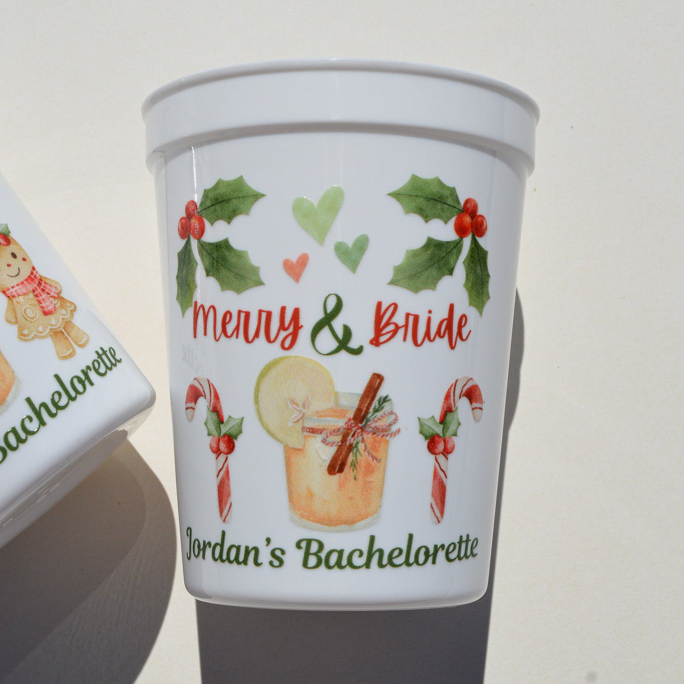 Personalized Christmas-themed cup with festive design and text on a plain background