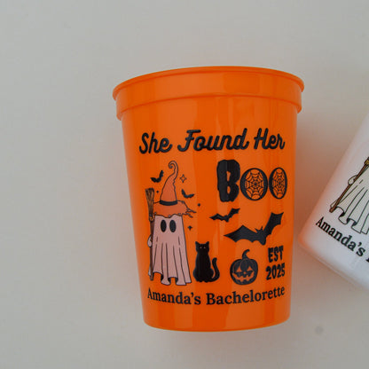 Orange cup with Halloween-themed design and text on a white background