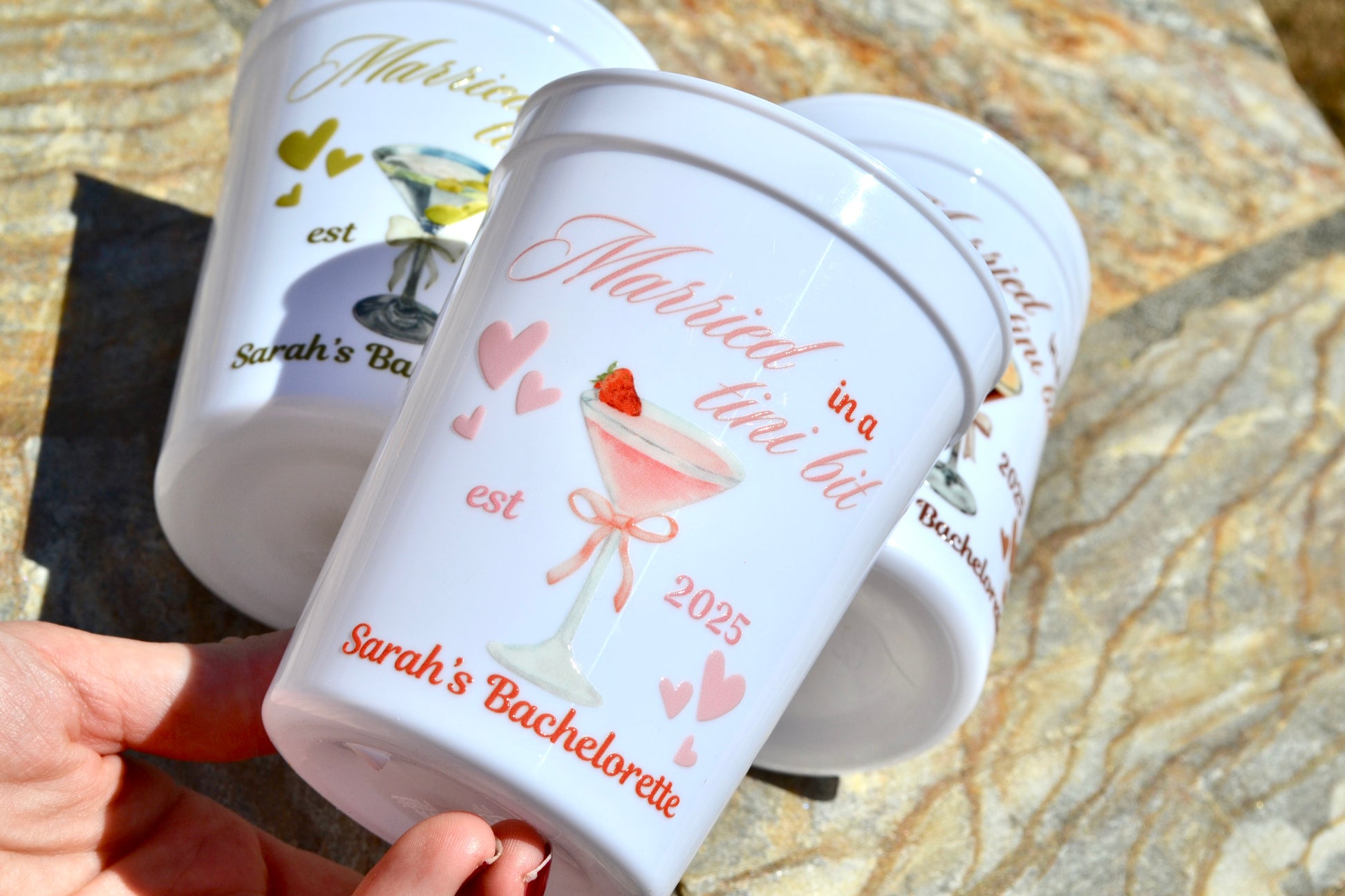 White cup with married in a tini bit in pink text against a stone background