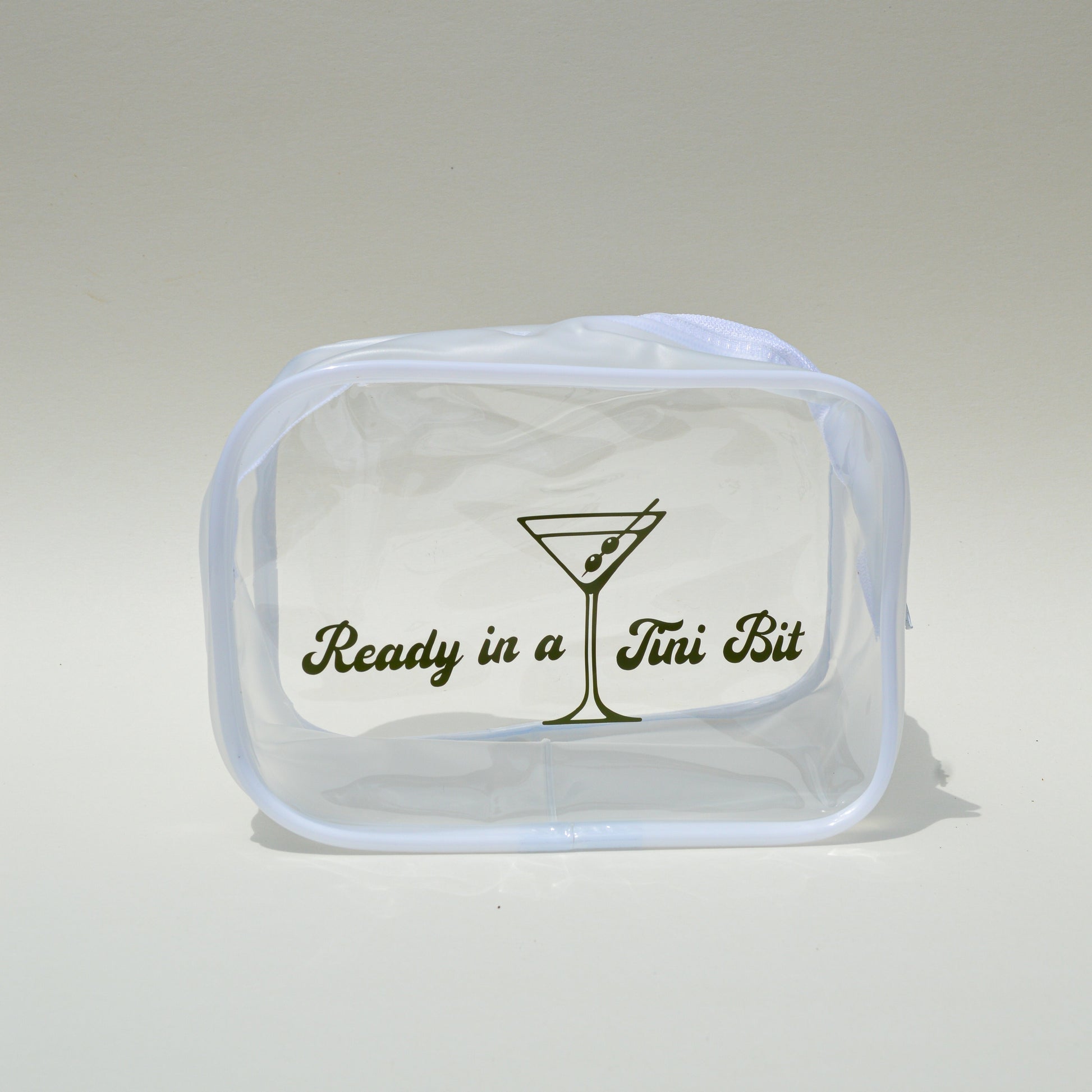 Clear pouch with text and a martini glass design on a light gray background