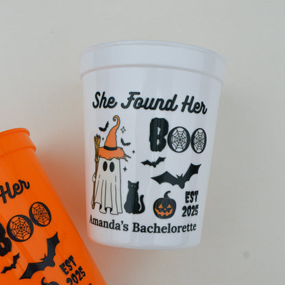 Halloween-themed cup with graphics and text on a plain background