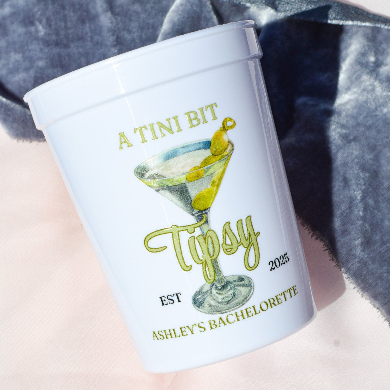 White cup with 'A Tini Bit Tipsy' design and text