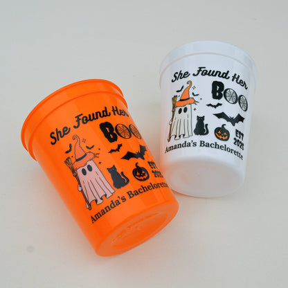 Two Halloween-themed cups on a white surface